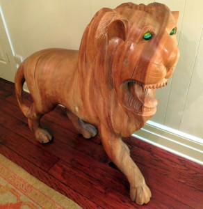 Beautiful lion made of one piece of wood. His blue and yellow marble eyes are intimidating.