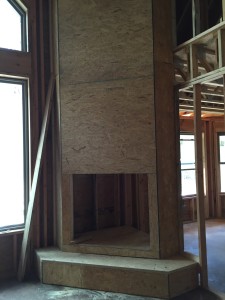A tall fireplace will anchor the downstairs living area.