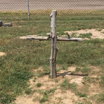 A beautiful, but humble, cross marks the location of someone's family member. It makes me think of the hymn, "The Old Rugged Cross."