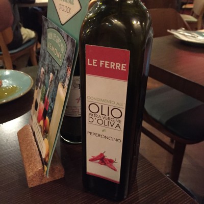 Chili pepper olive oil served with pizza at Speak Italian in London.