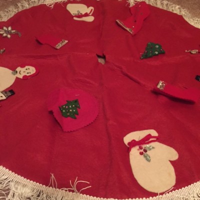 A felt tree skirt that probably was made by my Aunt E. She was a teacher, so maybe she used this one in her classroom (which would explain the felt decorations being stapled on).