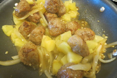 Onions, garlic, meatballs and pineapple are getting cozy in the pan.