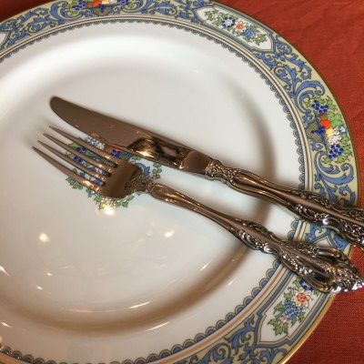 This is the traditional American signal that a person has finished eating. Fork and knife are placed in the 4 o'clock position on the plate.