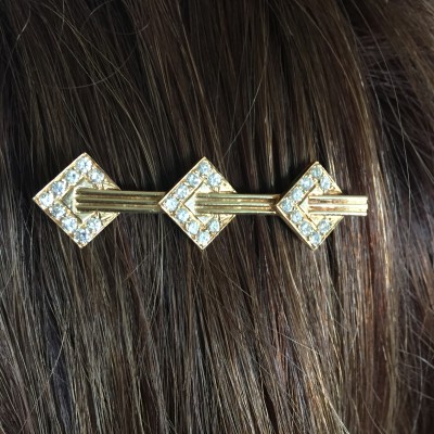 This barrette is 14 kt yellow gold with diamonds. It looks lovely in the evening light.
