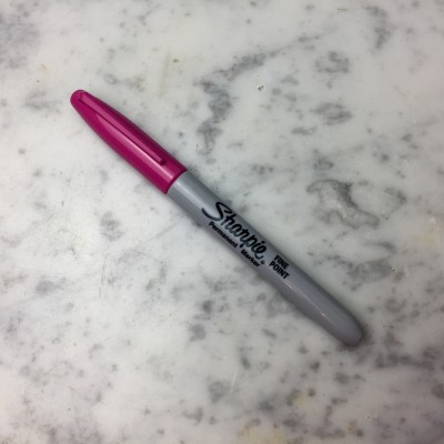 A permanent marker to the rescue. Of course, I choose hot pink to mark my clothes!