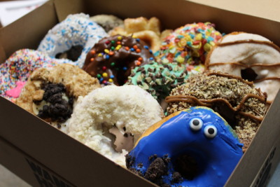 A box of Hurts Donuts. That is the cookie monster in front.