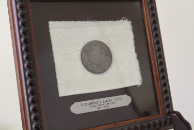 I had my grandfather's lucky coin framed along with the swatch of fabric in which he wrapped it to carry in his pocket. 