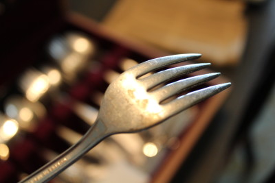 A silver-plated fork shows the base metal underneath the silver.
